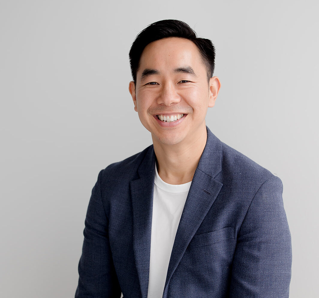 Man smiling at camera in navy suit jacket