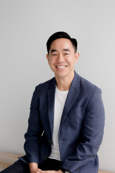 Man smiling at camera in navy suit jacket
