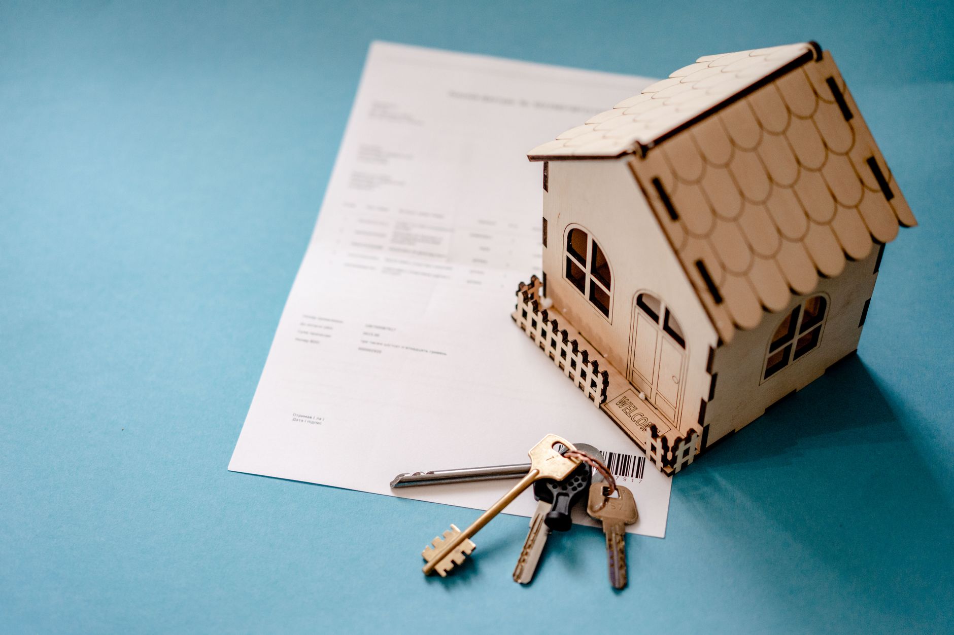A model house with keys and a contract, the rules and risks of holding property in super