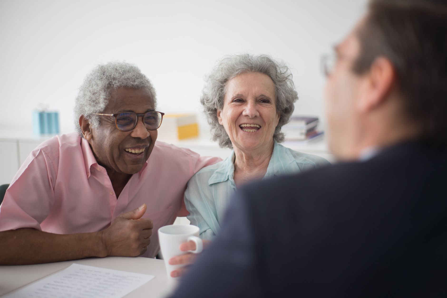 An older couple with an adviser, discussing what super can and cannot be used to buy