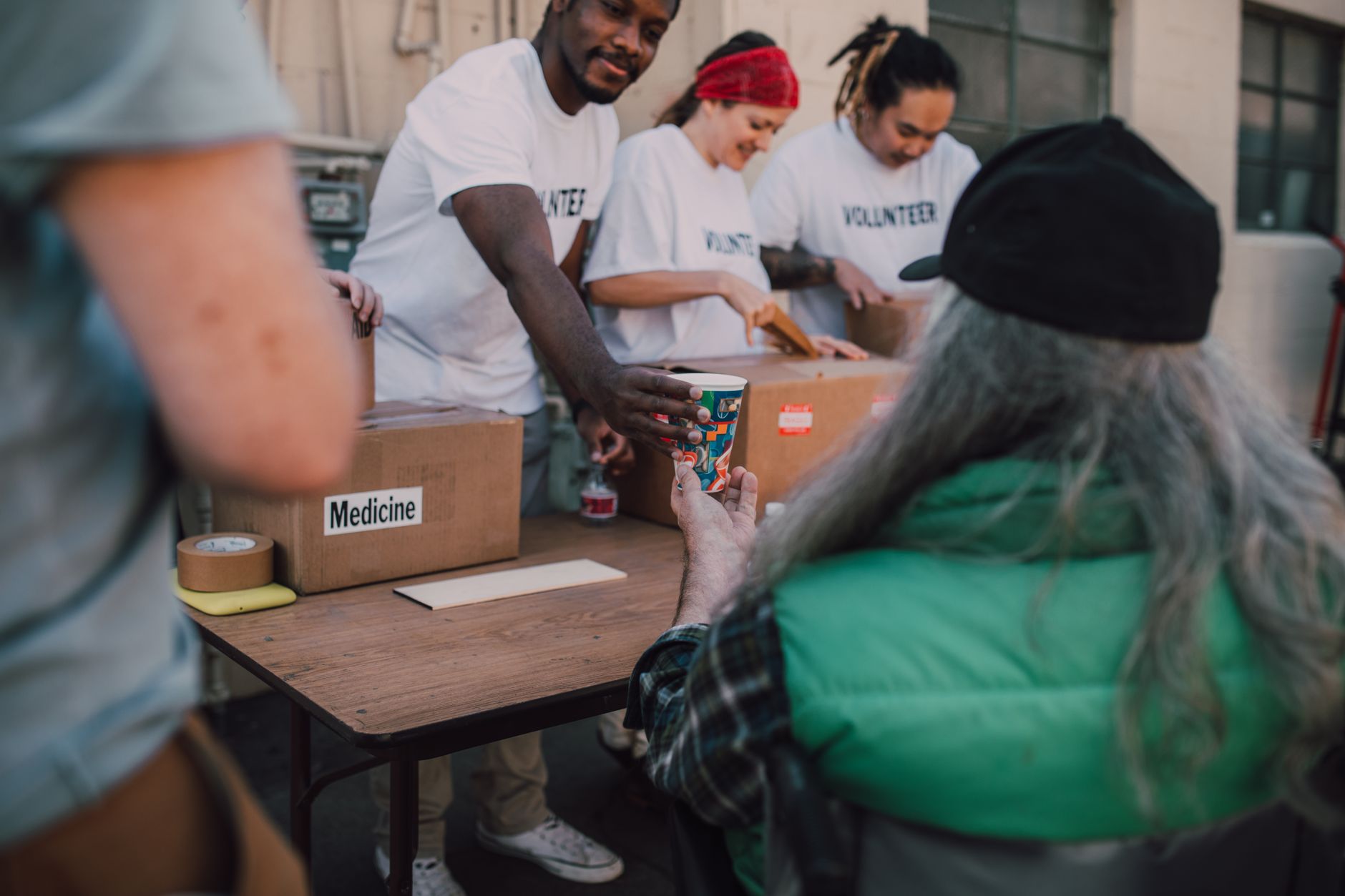 Volunteers handing out support at a community centre, the work funded by 10% of trail income