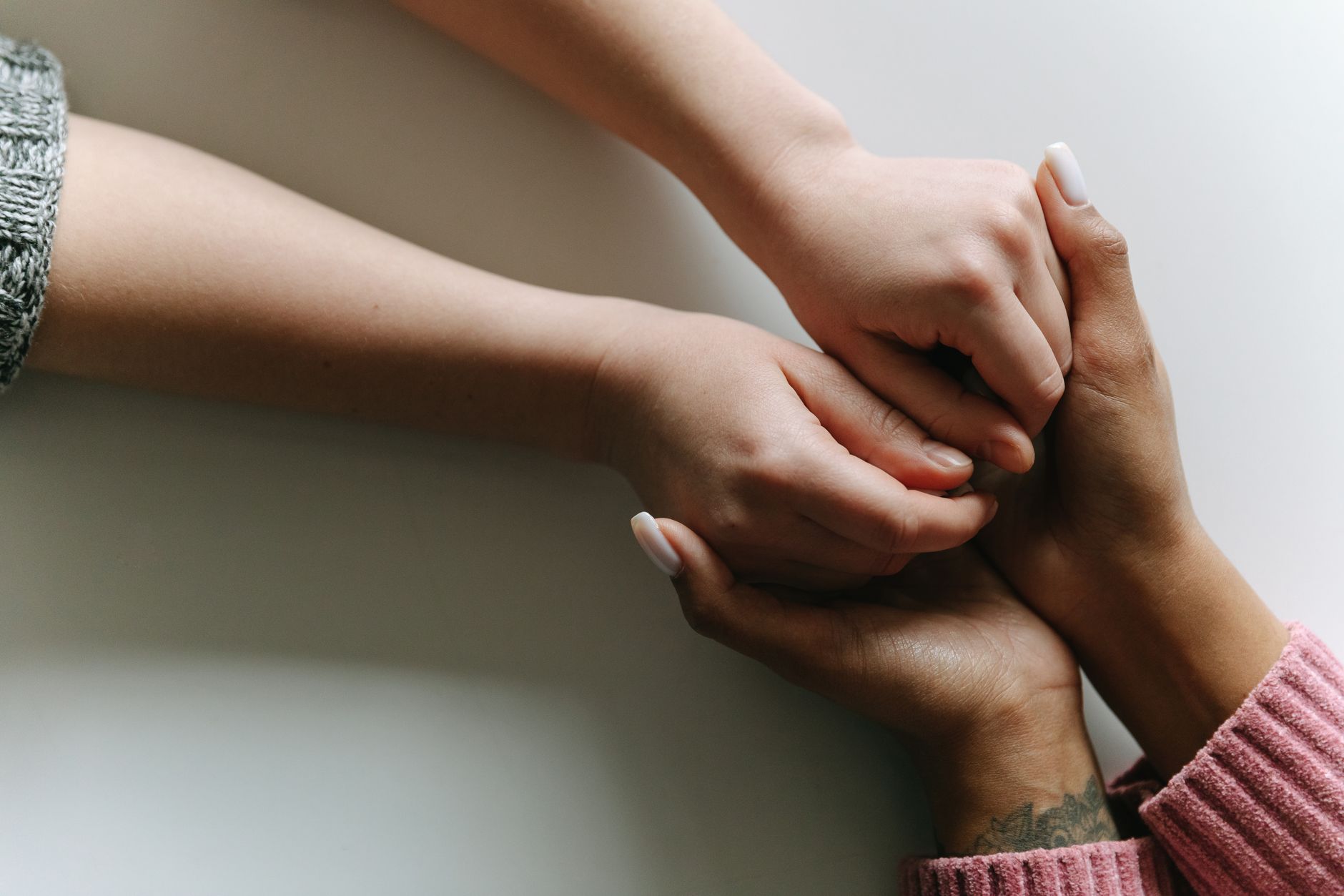 Hands held together, representing the anti-trafficking work funded by 10% of Loan Lounge's trail income
