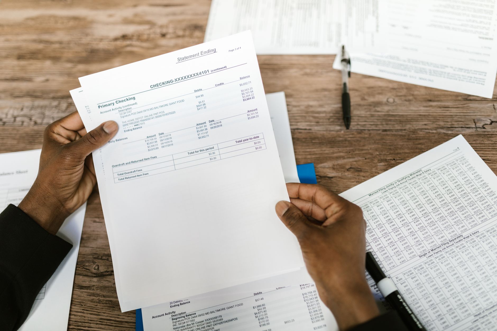 An accountant reviewing financial statements, the return a lender later assesses for borrowing power