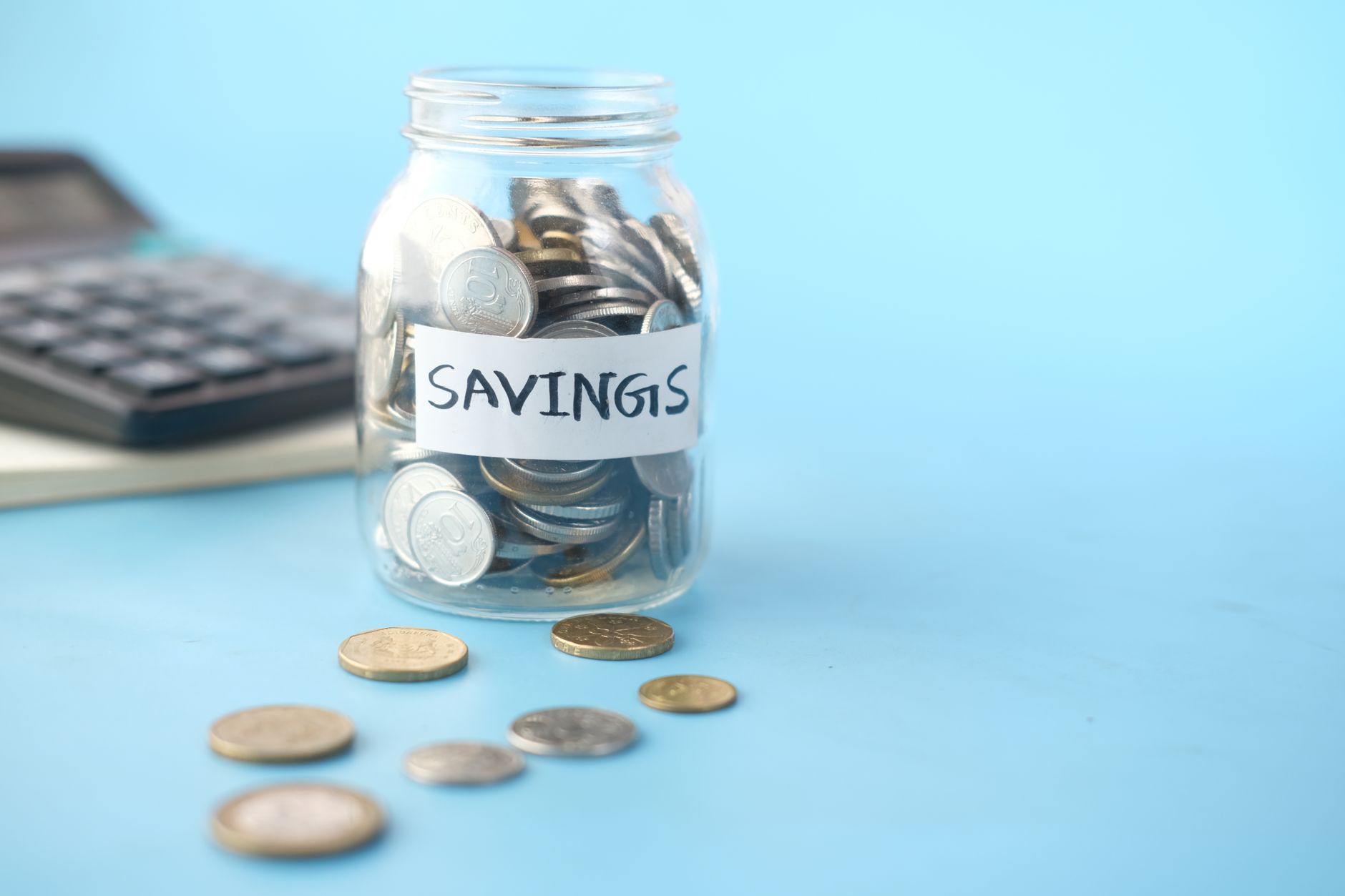 A savings jar and calculator, the cost of an old home loan nobody has reviewed