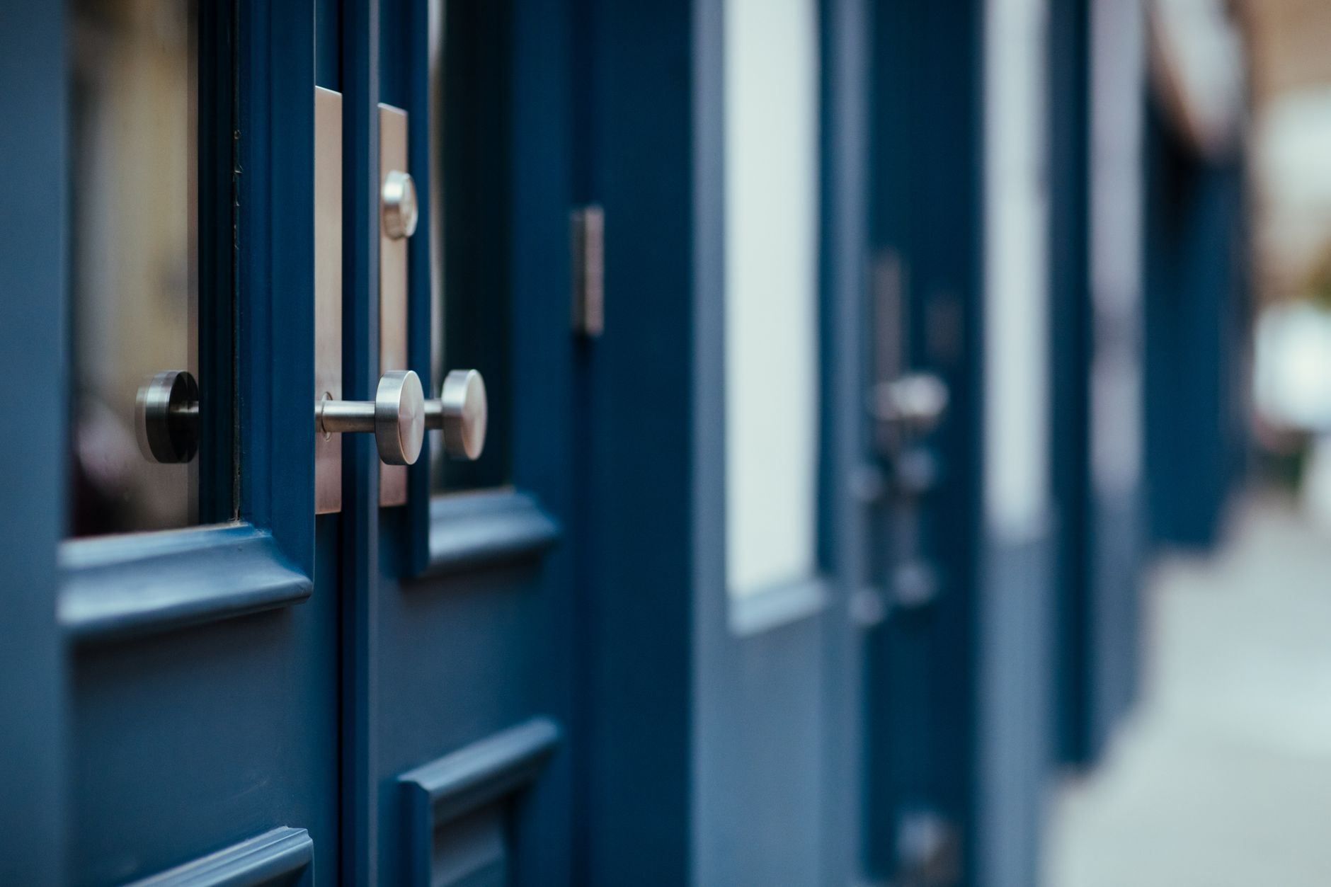 A row of different doors, representing the different lender credit policies a broker can access