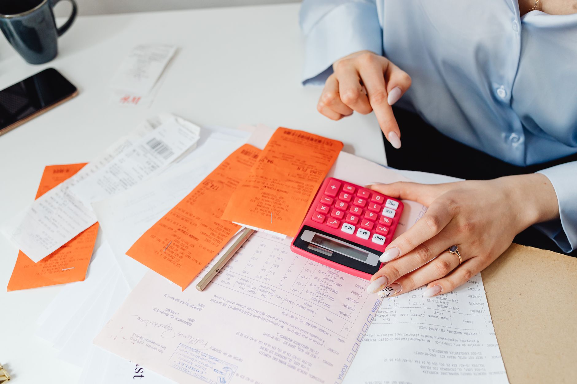 A calculator and receipts, the costs that make an SMSF loan more expensive than a standard one