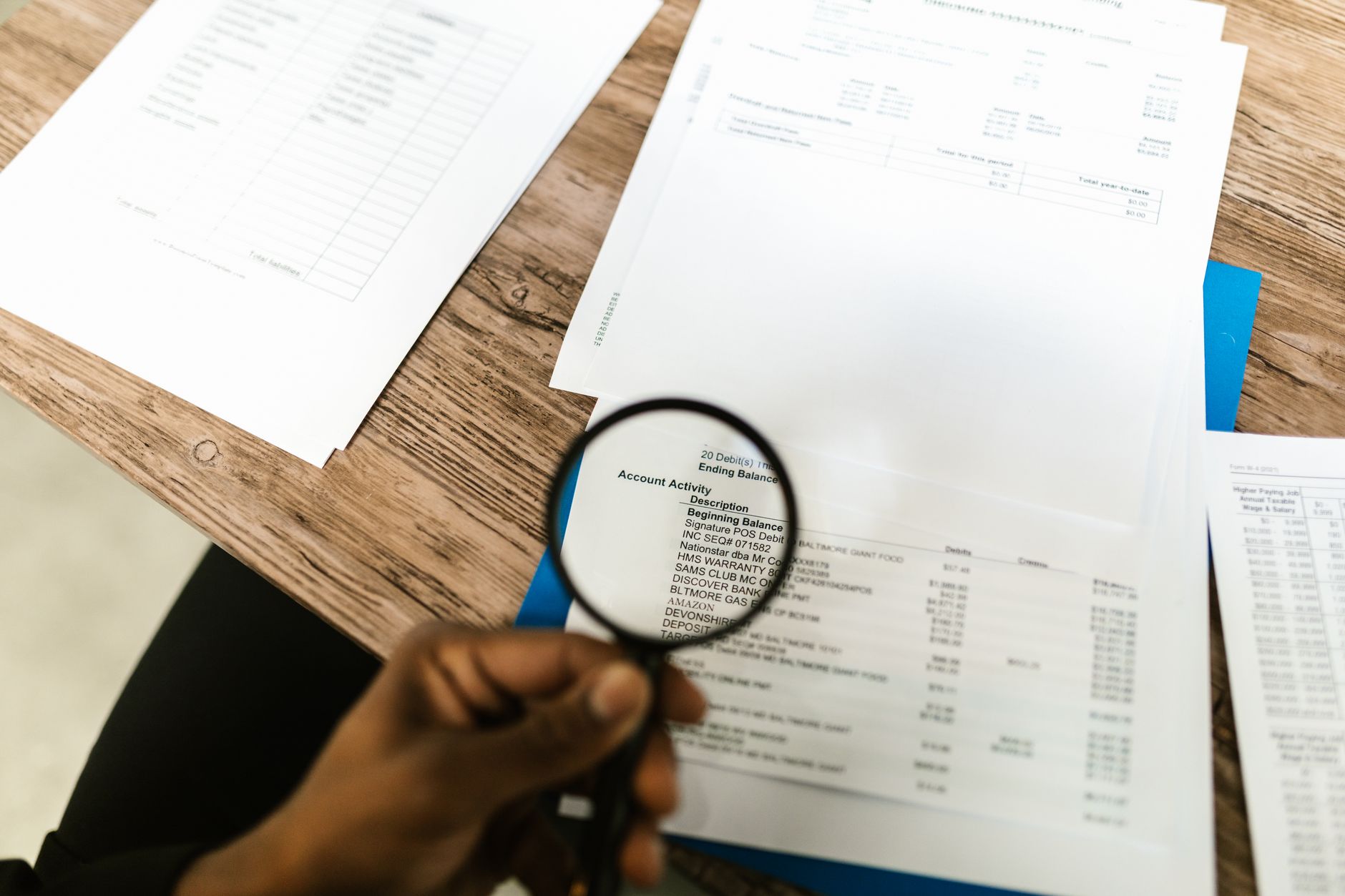 A magnifying glass over documents, comparing which lenders still write SMSF loans